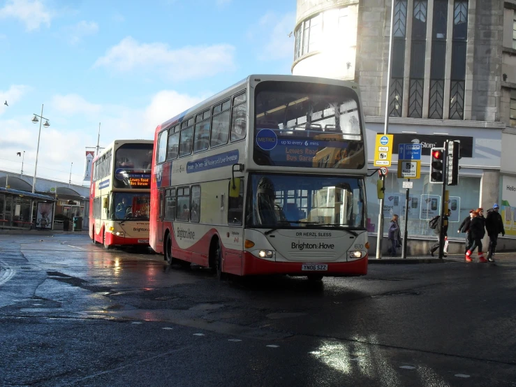 a double decker bus is driving through a crosswalk