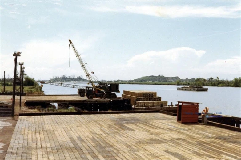 a crane is on a platform near the water