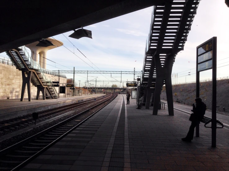 a man waiting at the railway station for his train