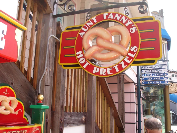 a restaurant sign with giant letters hanging on a building