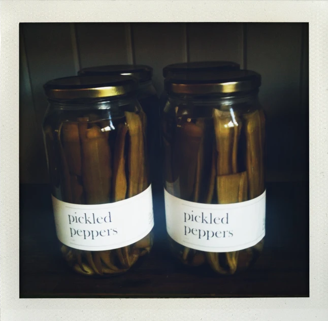 two jars of pickles are labeled with labels