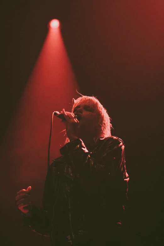 an image of a person on stage playing on microphone