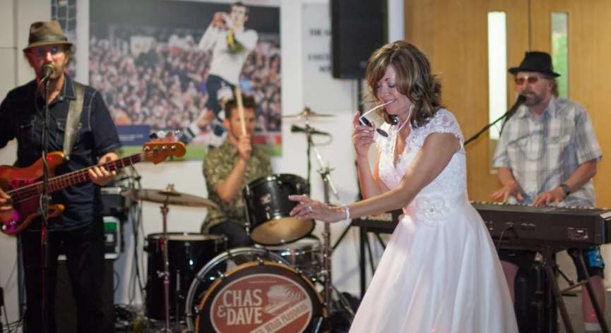 a woman on stage singing to a band