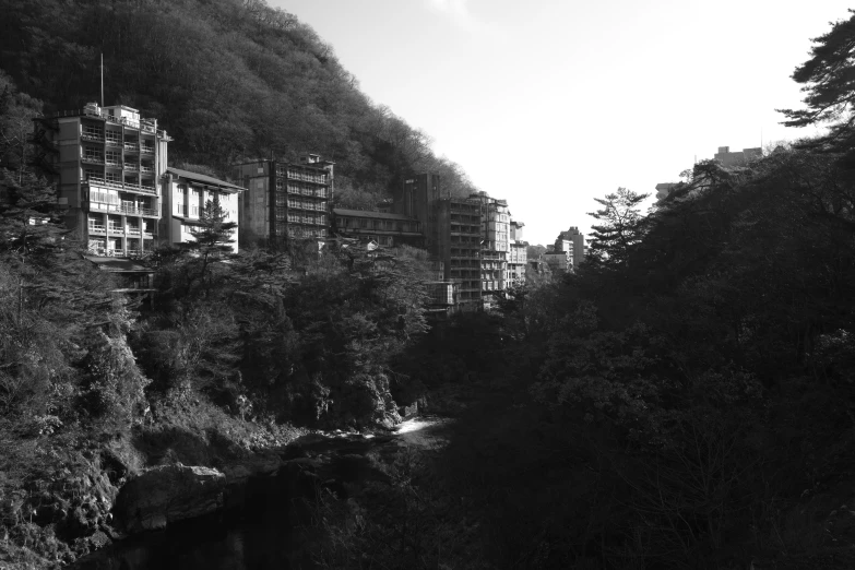 a black and white image of a mountain city