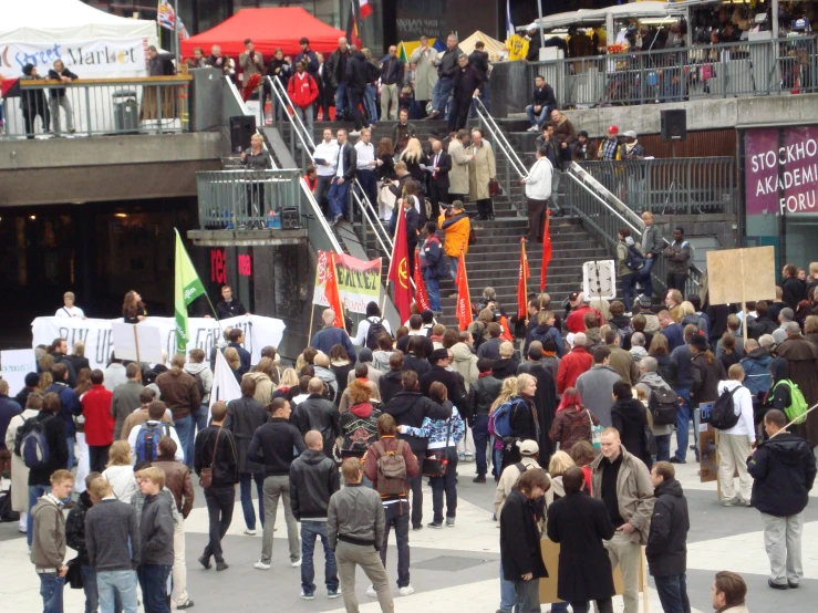 a group of people holding signs and banners