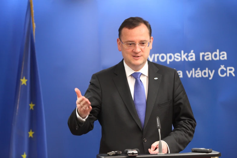 the man is standing in front of a podium