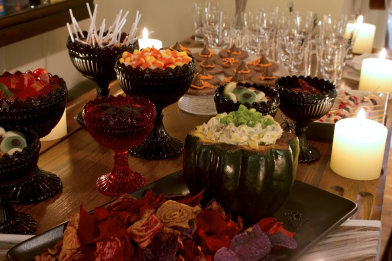 a table filled with dishes and candles and glasses