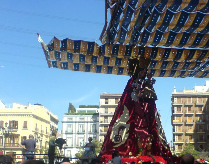 a man is performing with a pole and some kites