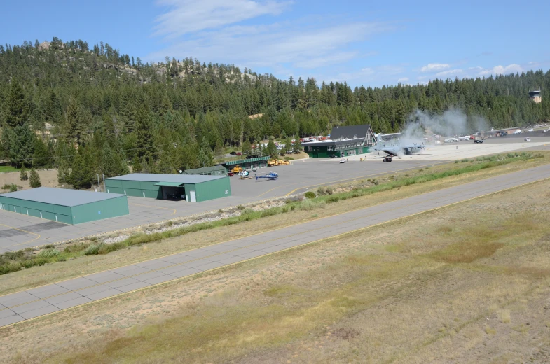 a large parking lot with smoke coming from the top of it