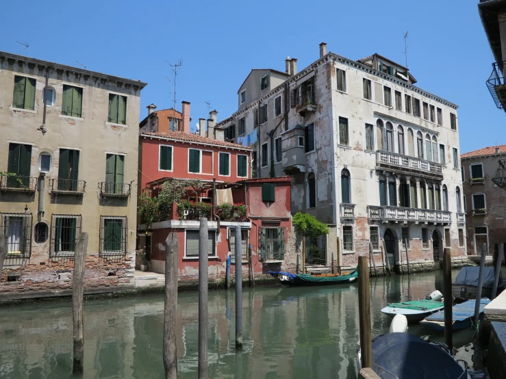 a canal that has some boats near buildings on it