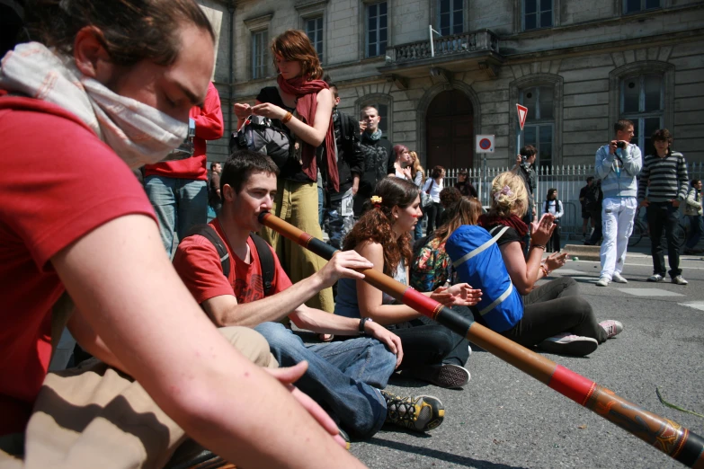 a group of people sitting in the street