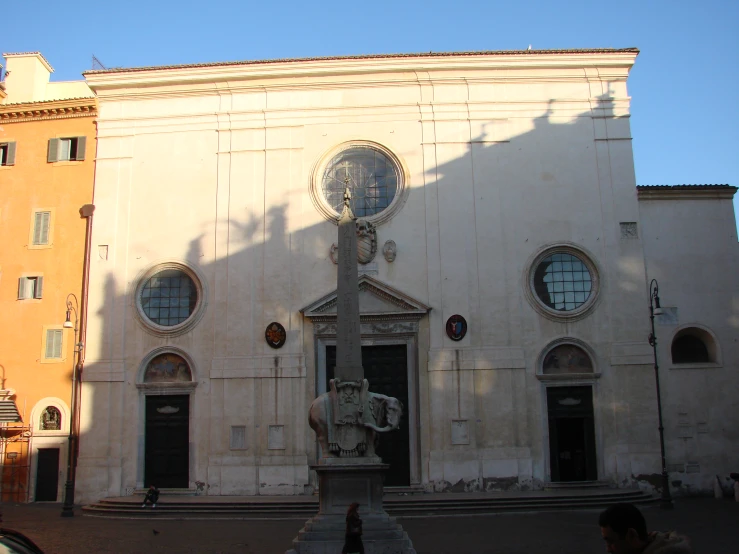 the front of a building with several round windows