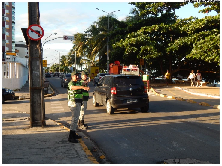 the boy is standing on the street corner