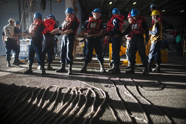 people with safety vests stand together in a line