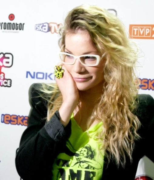 a woman with long blonde hair in glasses
