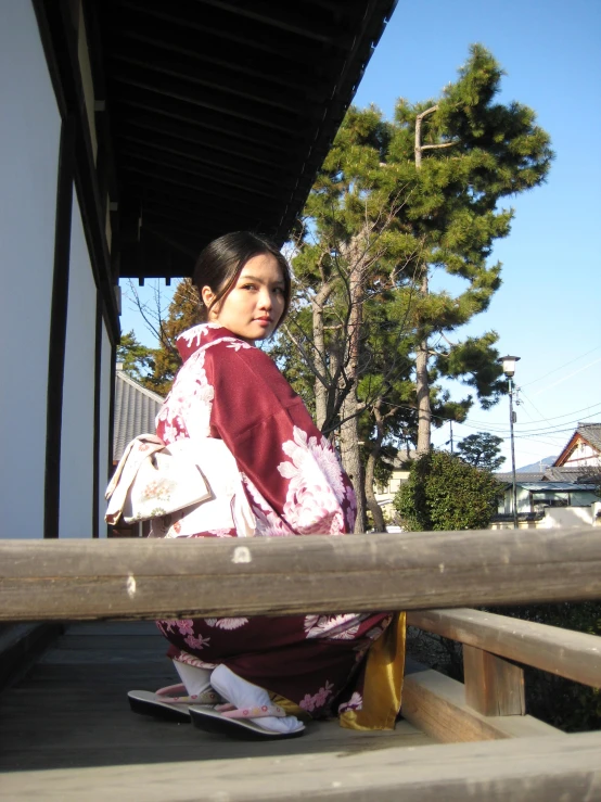 a person sitting in front of trees on a skate board