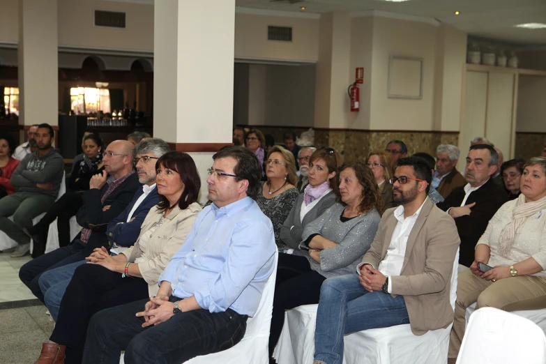 a group of people are listening to a lecture