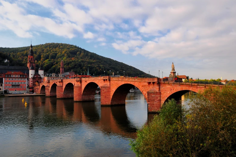 a large red bridge over a river with boats