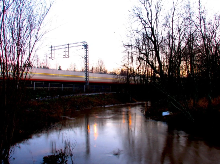 a train that is going down the track next to a water body