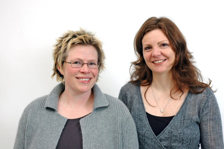 two women with glasses pose for a picture