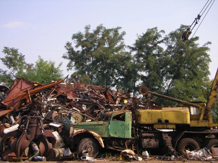 an old tow truck is piled with scrap