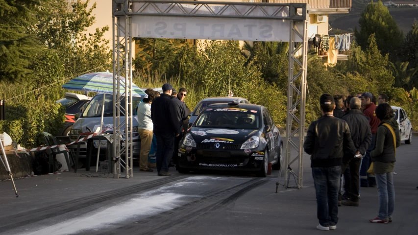 people gathered near cars at the start line