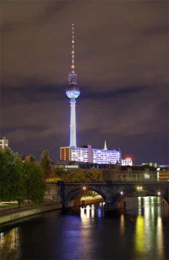 the television tower and bridge in the city at night