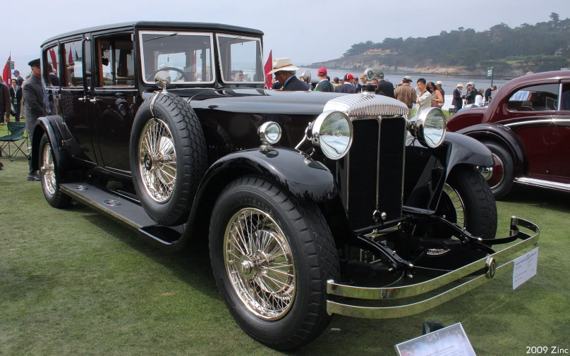 old model black car sitting on display at a car show