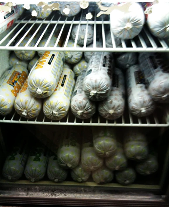 a fridge filled with lots of produce and some bread