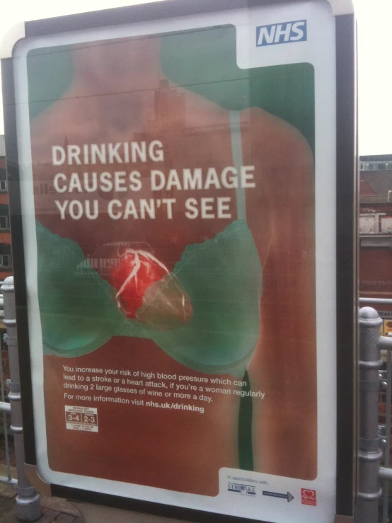 a sign on a building that warns that drinking can cause damage