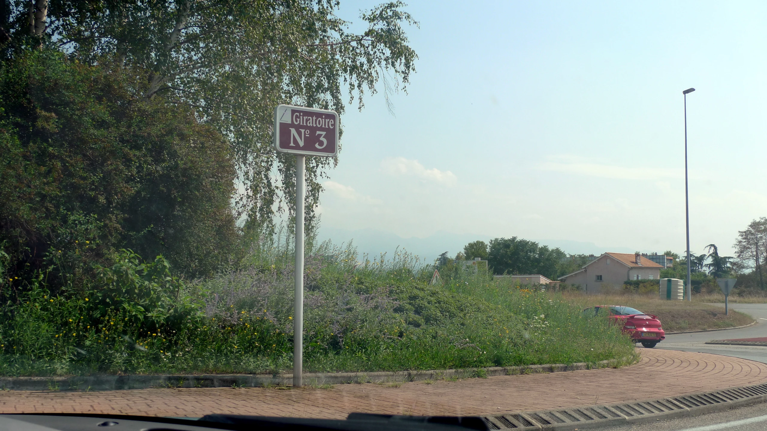 street signs at the corner of a suburban road