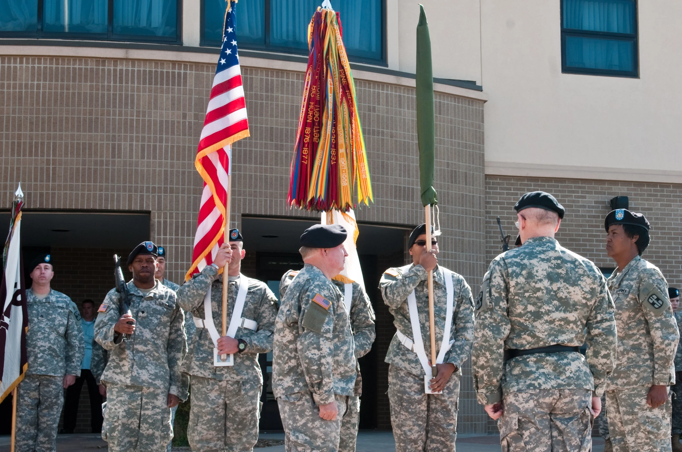 the military march to receive their colors at attention