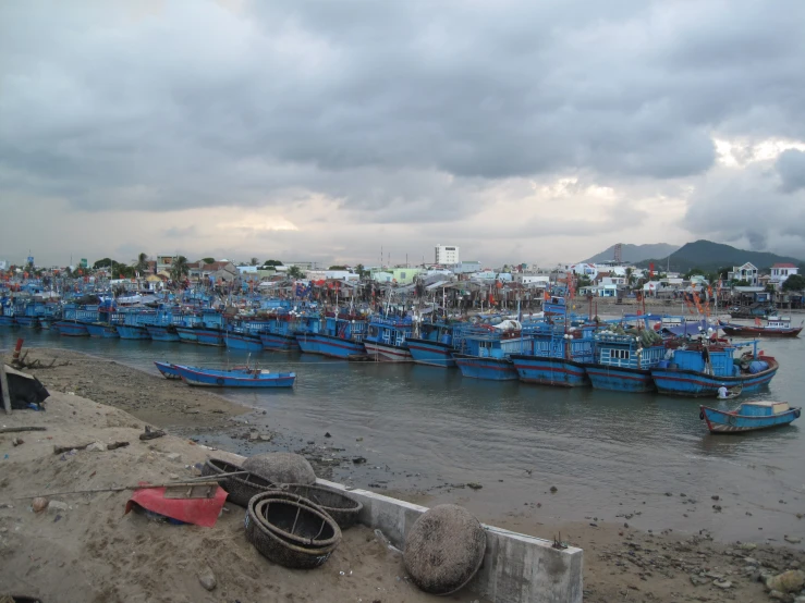 a beach with a lot of boats parked at the shore