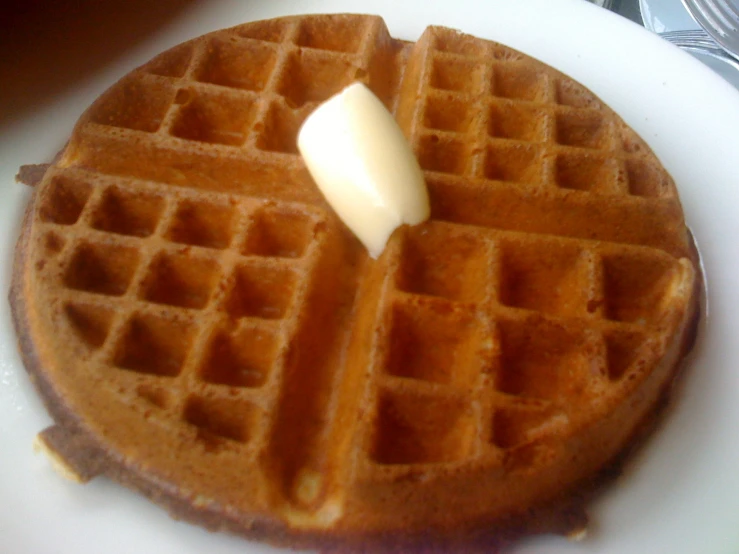 a stack of waffles topped with er and syrup