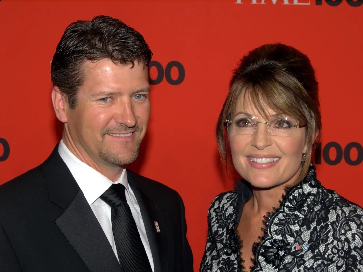 a man and woman dressed up for a red carpet event