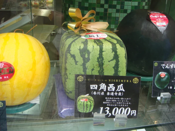 there are watermelons in a display in a market