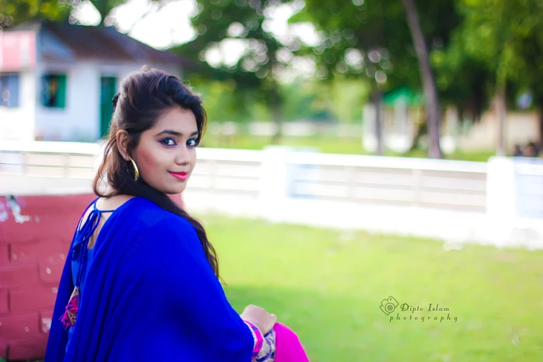 a woman in a blue outfit is posing for the camera