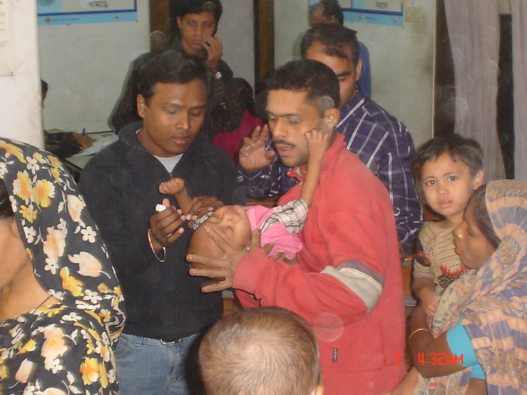 a group of people that are standing in the room