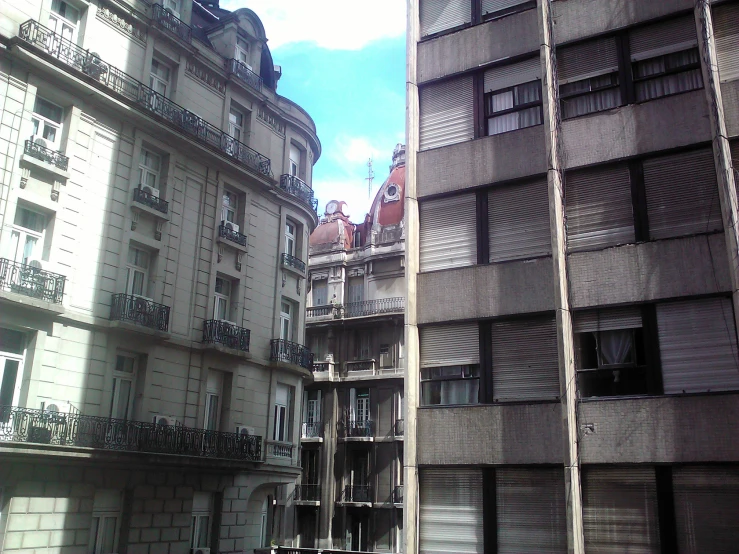 an image of city buildings with some shutters on the windows