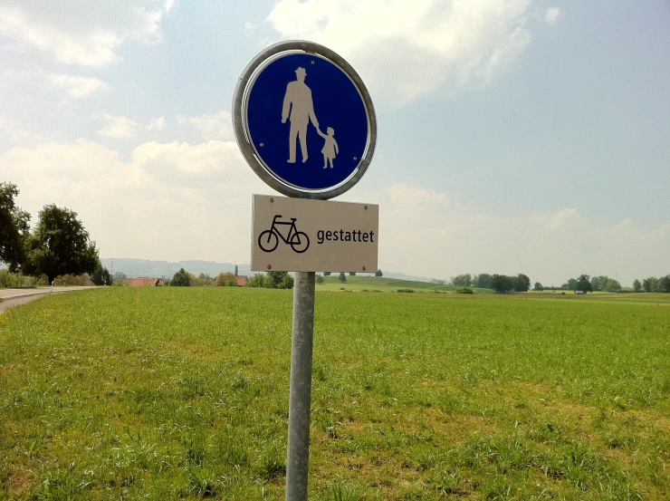 a blue and white sign on top of a pole