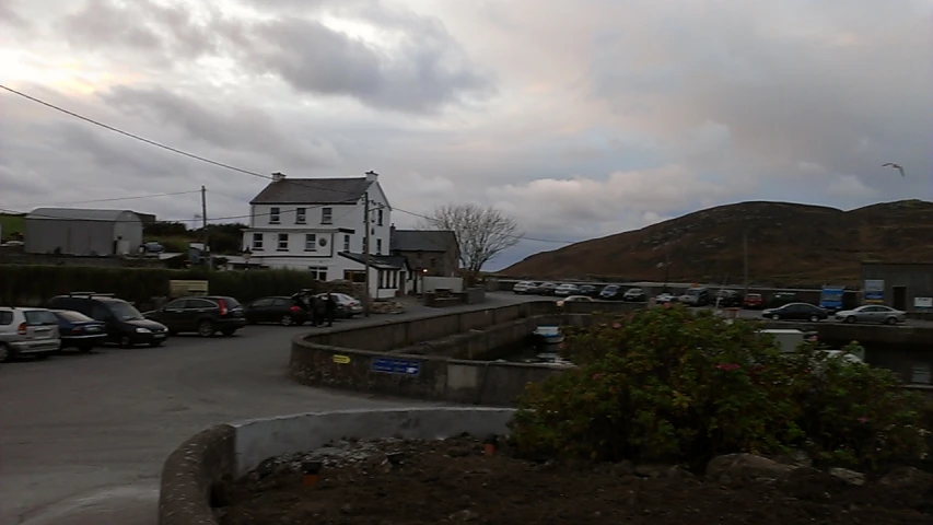 a white house with cars parked outside in a lot