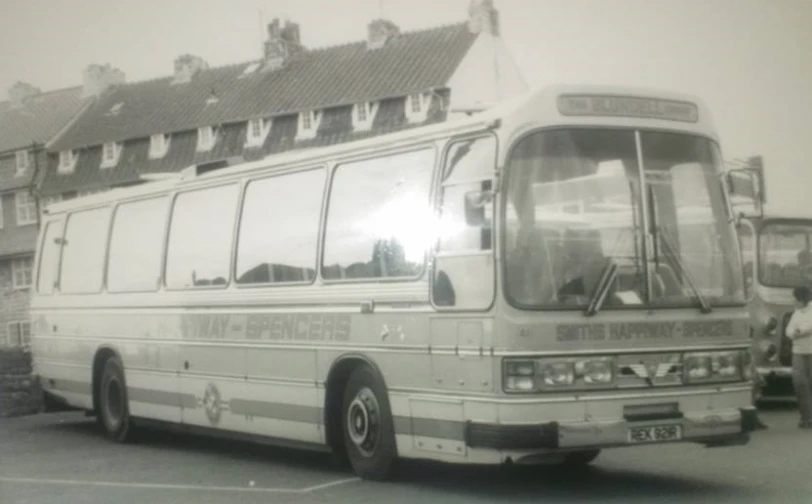 a long bus parked on the side of a street