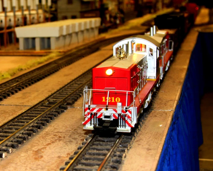 an image of a red train going down the tracks