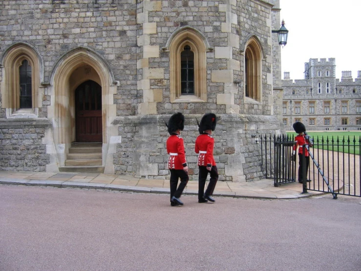 two guards standing in front of a castle with doors