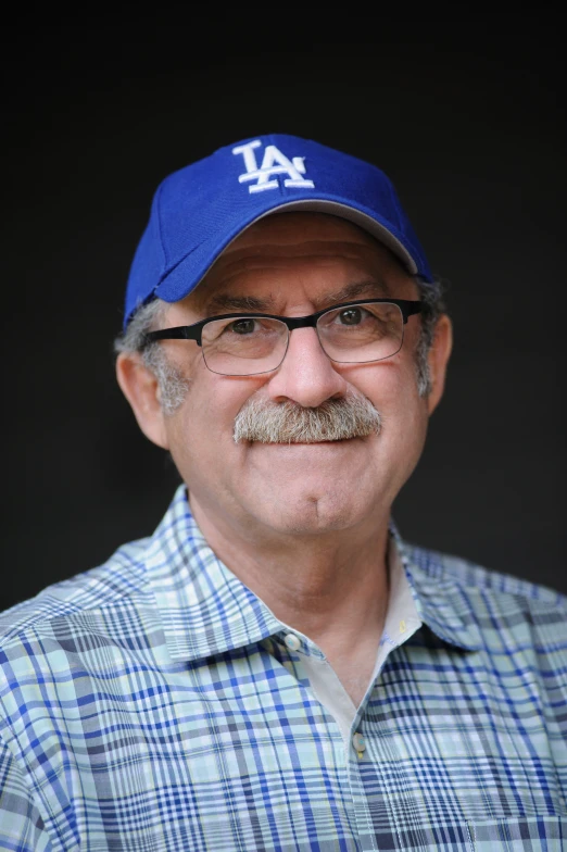 a man wearing a baseball cap and glasses