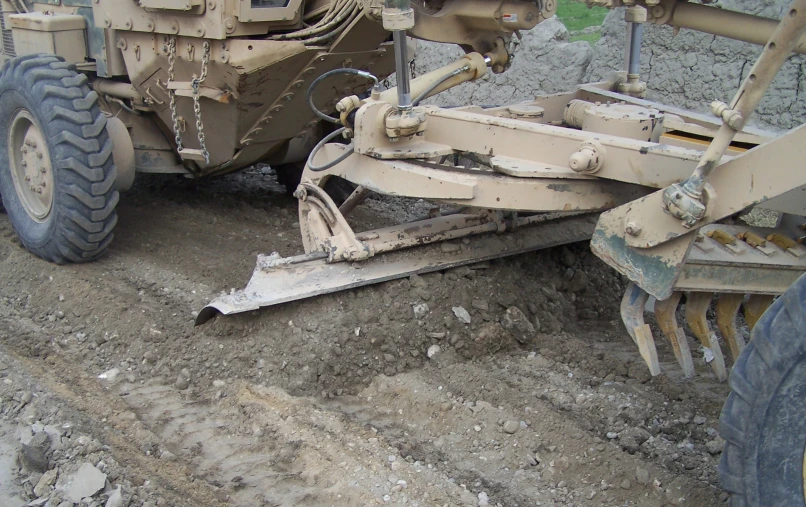 a large tractor is sitting in the dirt