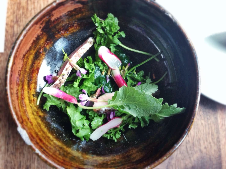 a bowl filled with green, red and purple food