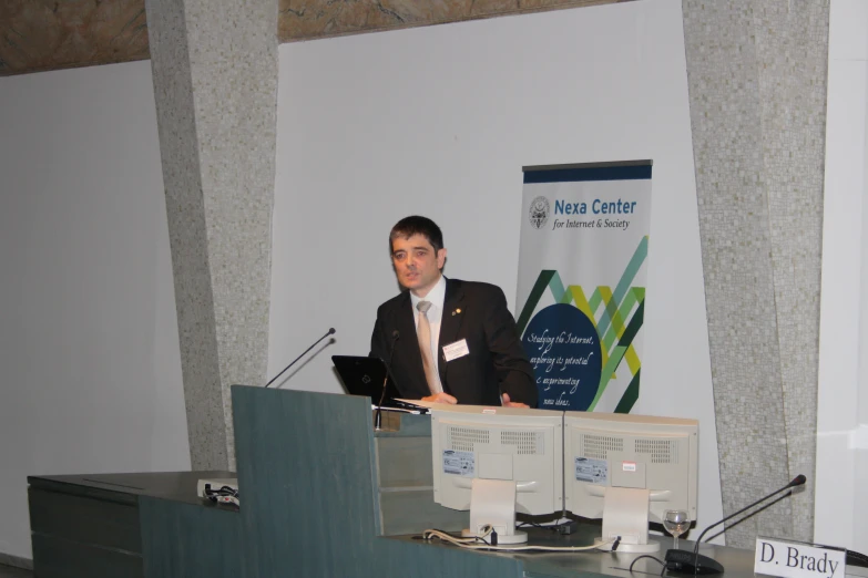 a man giving a speech in front of a podium