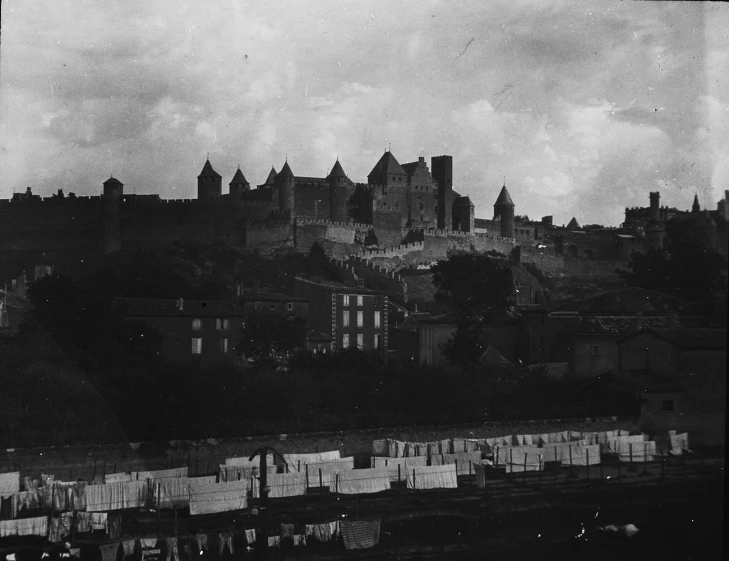 a large castle sitting on top of a hill next to buildings