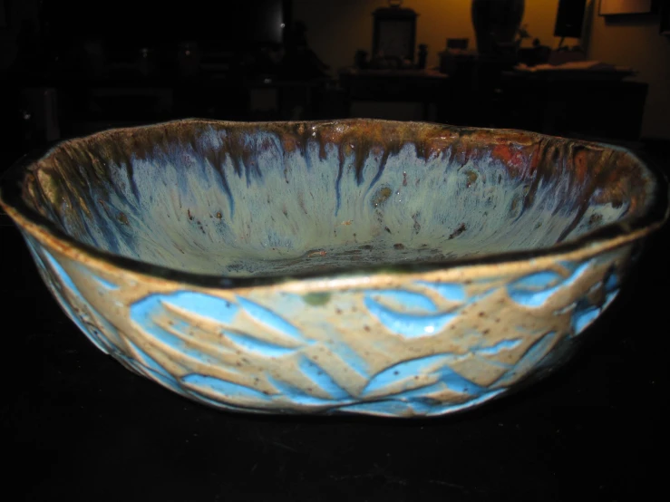 this bowl is blue and has brown designs on it